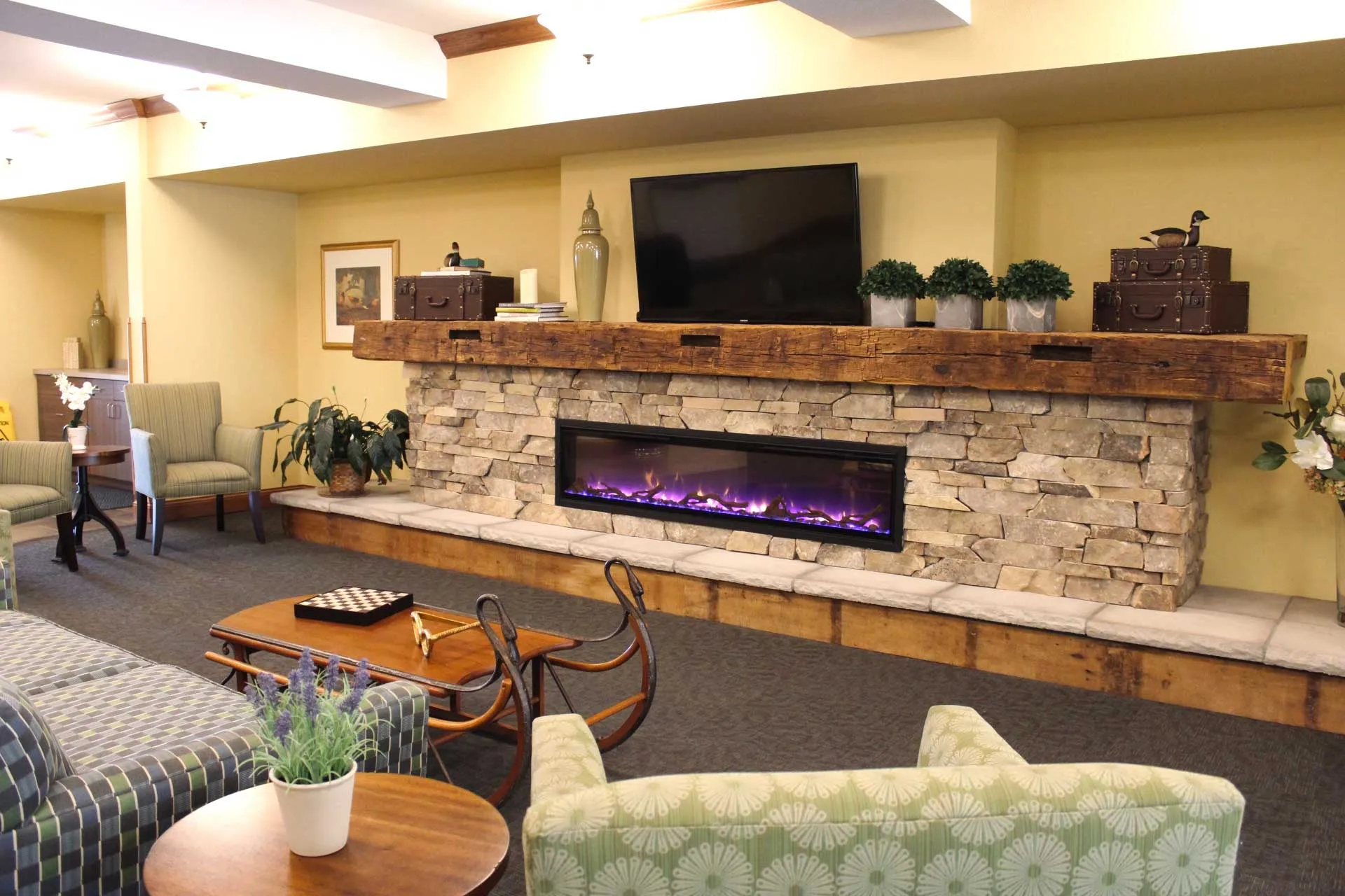 A cozy living room with a fireplace and TV, perfect for residents of independent living.